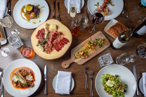 A full table of delicious Italian dishes.